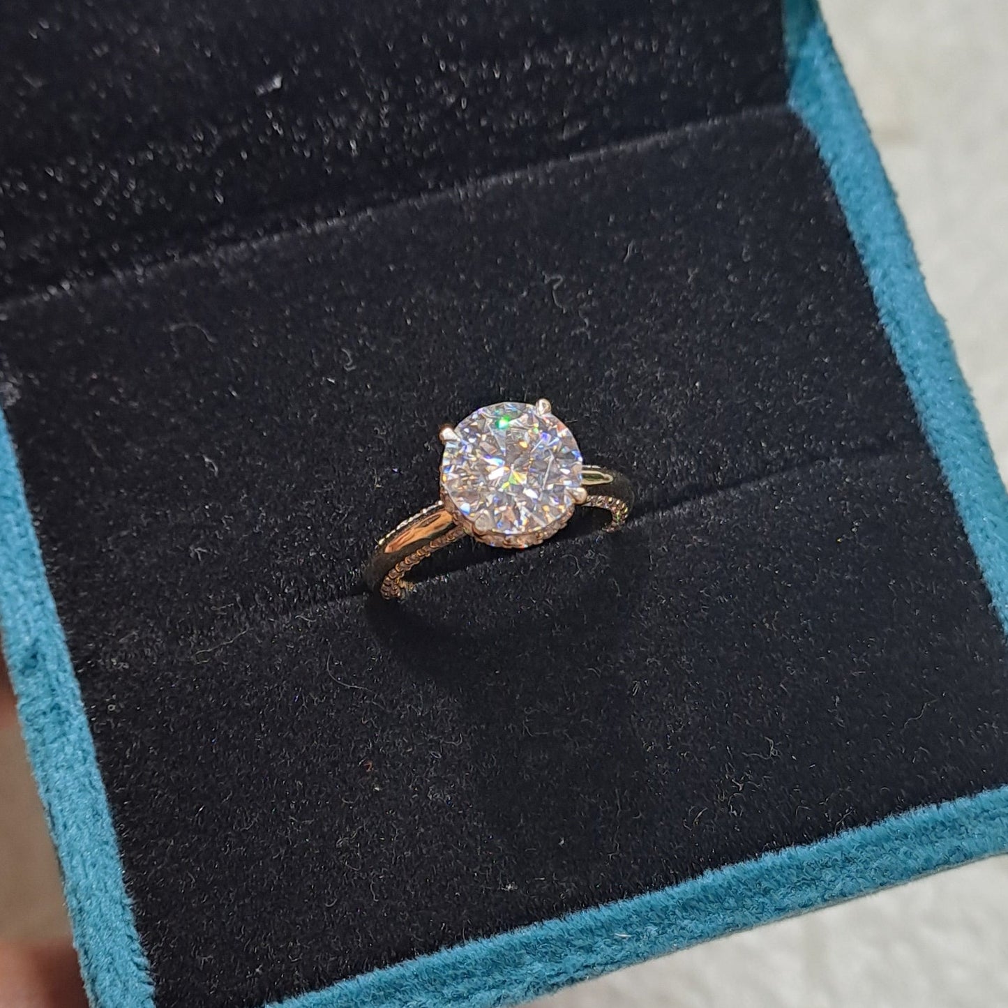 Elevate your love story to new heights with our mesmerizing solitaire ring featuring a breathtaking 2-carat center stone, accented by dazzling side stones.