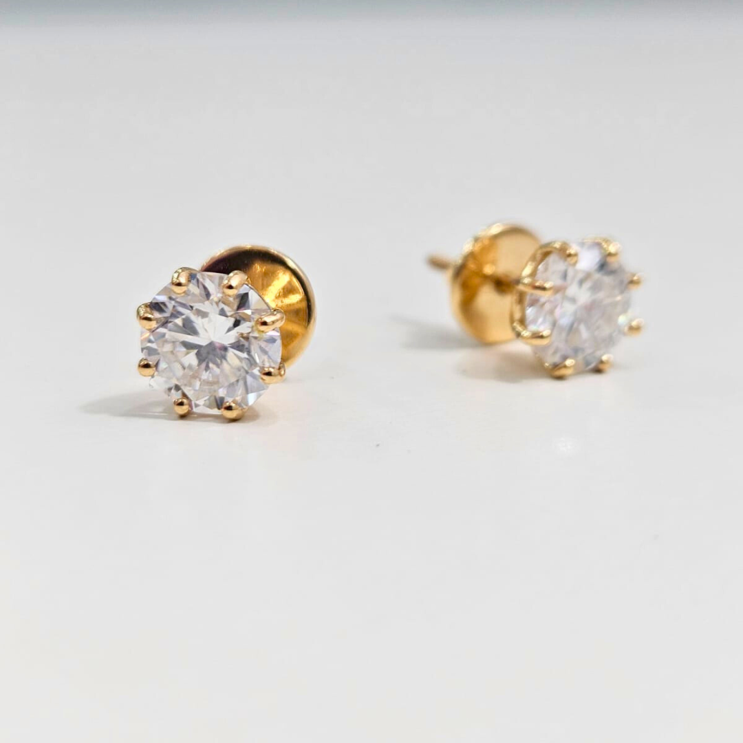 8 prong Gold stud earrings with clear gemstones on a light gray background