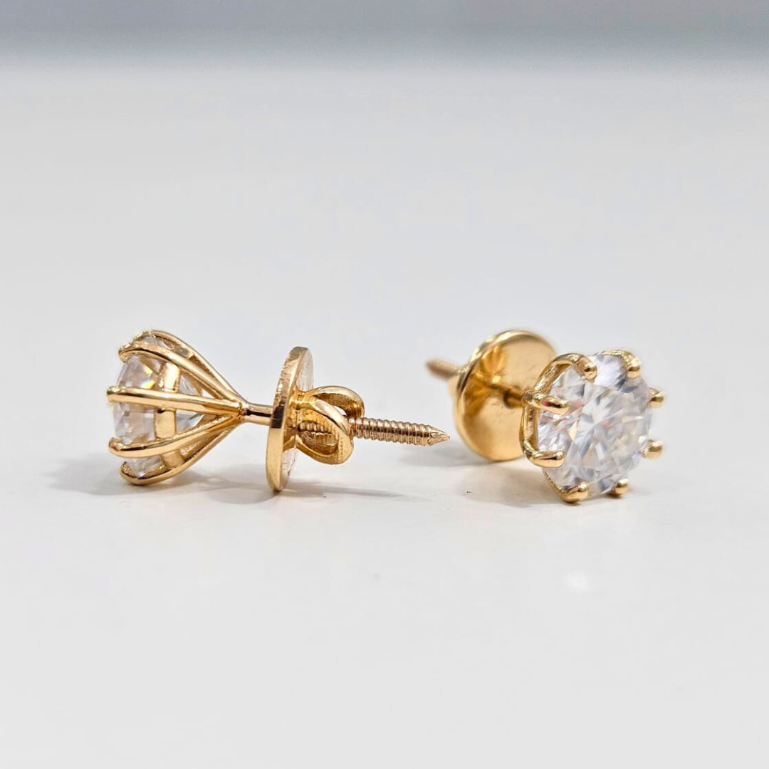 8 prong Gold earrings with clear gemstones on a light gray background