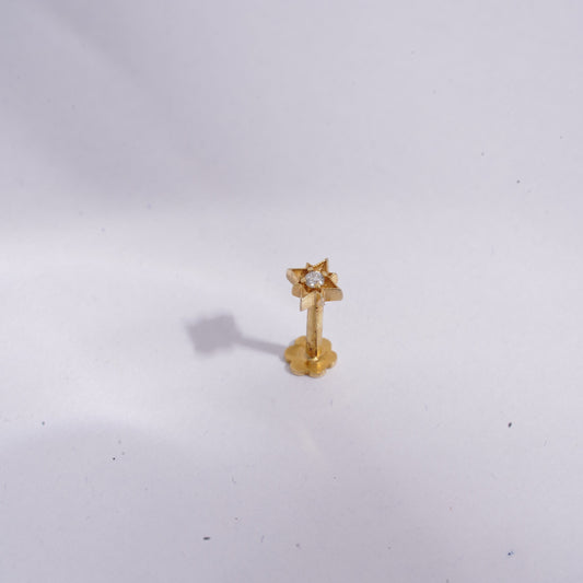 Gold earring on a white background