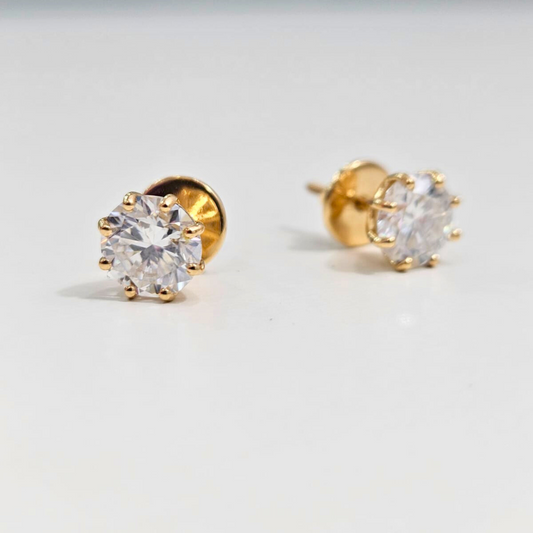 8 prong Gold stud earrings with clear gemstones on a light gray background