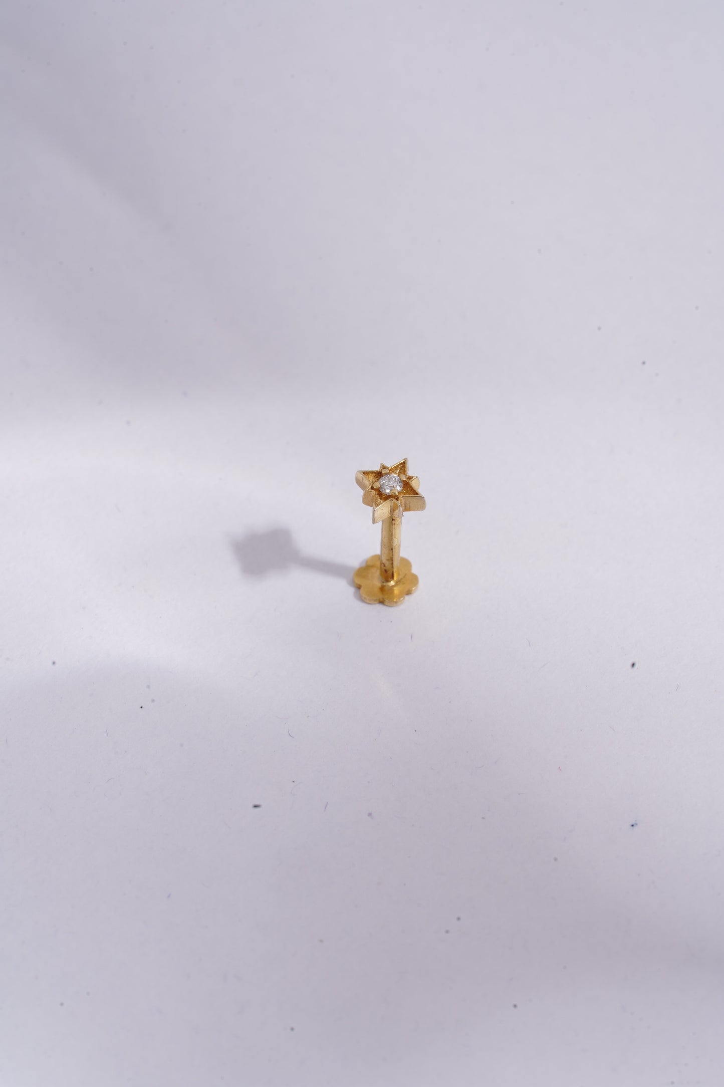 Gold earring on a white background