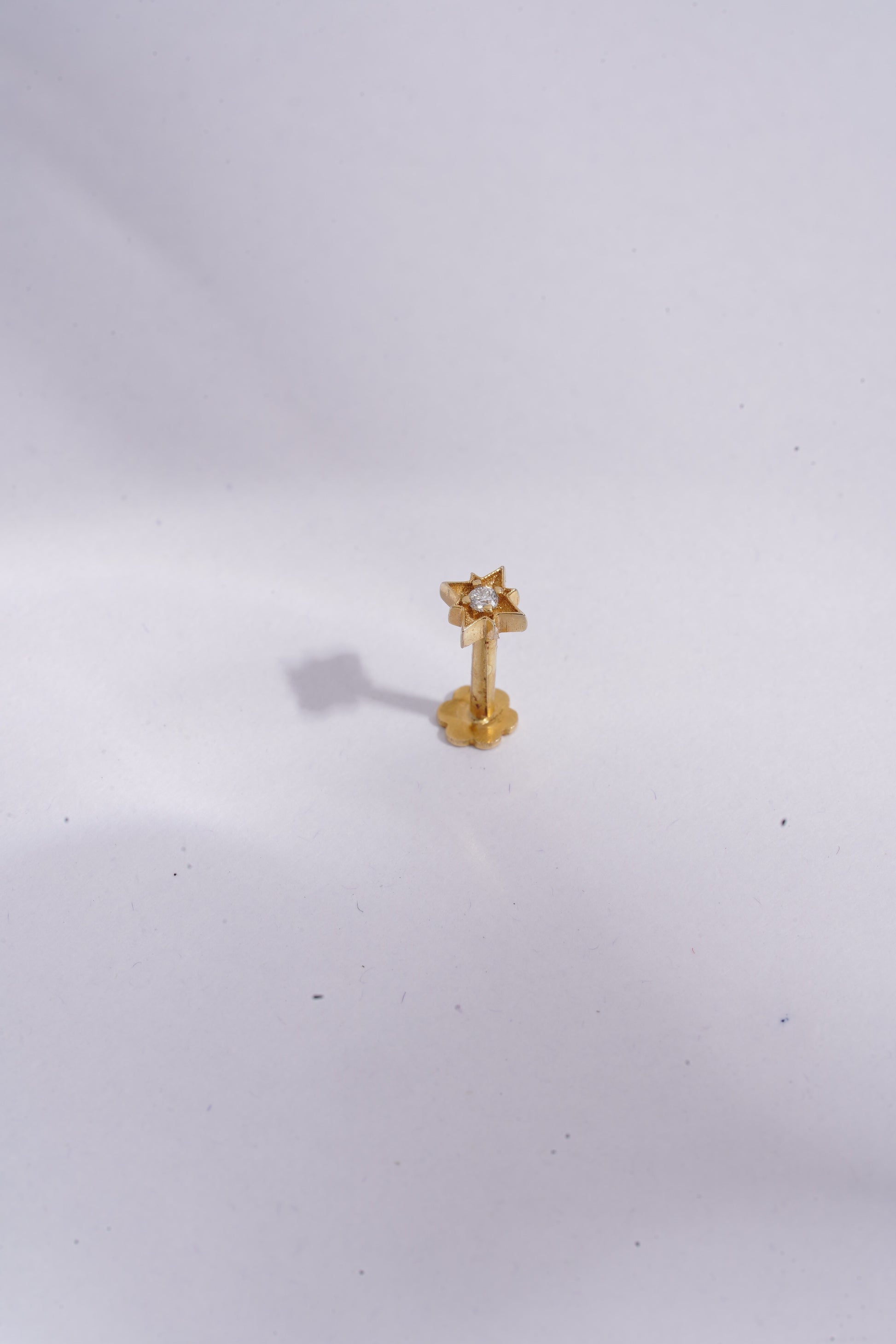Gold earring on a white background