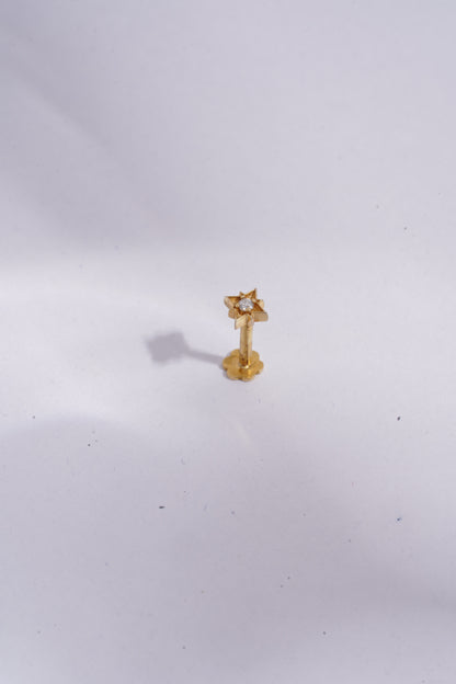 Gold earring on a white background